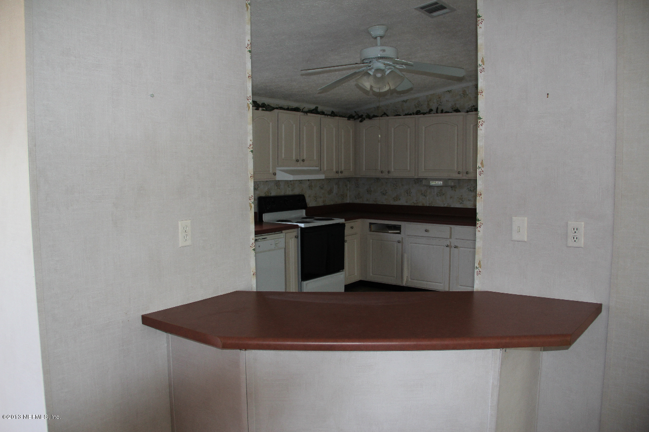 1999-2001 Ryan Road St. Augustine, FL 32092 - Photo 25 of 48 a kitchen with a sink and cabinets