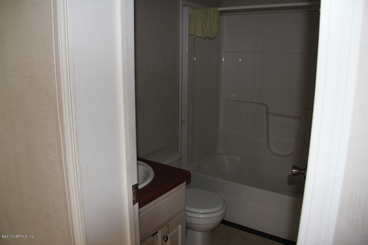 1999-2001 Ryan Road St. Augustine, FL 32092 - Photo 34 of 48 a bathroom with a granite countertop bathtub shower and toilet