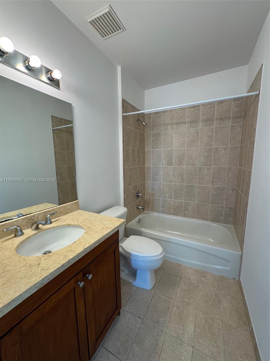 1723 Southwest 2nd Avenue, Unit P08 Miami, FL 33129 - Photo 14 of 21 a bathroom with a granite countertop sink a toilet a bathtub a mirror and shower