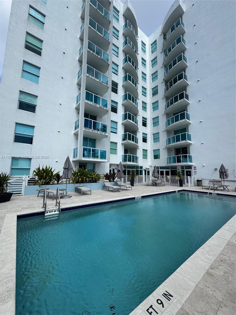 1723 Southwest 2nd Avenue, Unit P08 Miami, FL 33129 - Photo 18 of 21 a view of a swimming pool with a lawn chairs