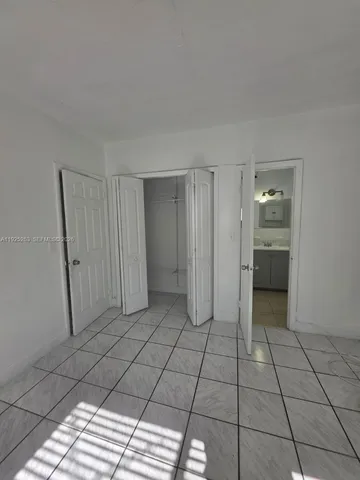 a bathroom with a toilet a sink a mirror and vanity