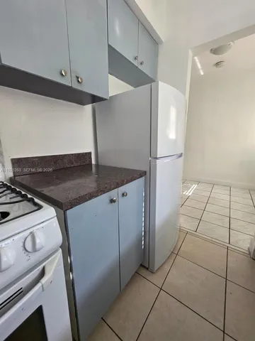 a room with a stove and cabinets