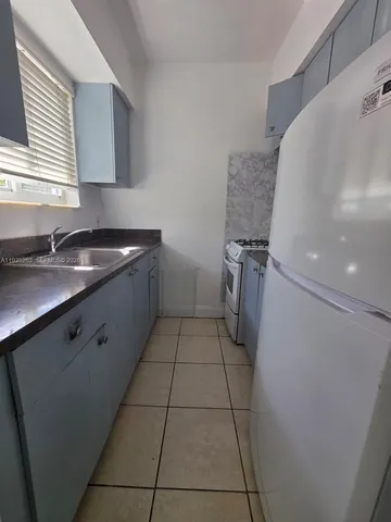 a room with washing machine and cabinets