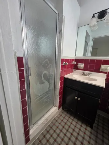 a bathroom with a toilet sink vanity and mirror