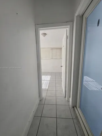 a view of a livingroom with an empty space and a window