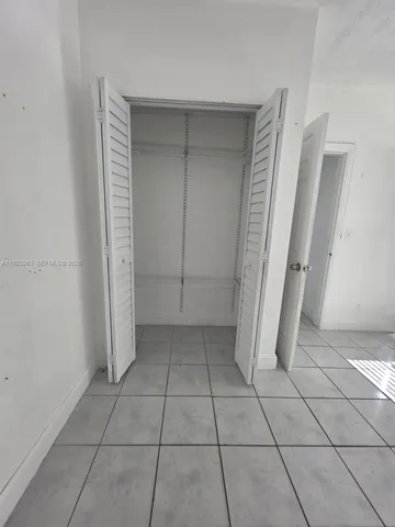 a view of a livingroom with an empty space and a fireplace