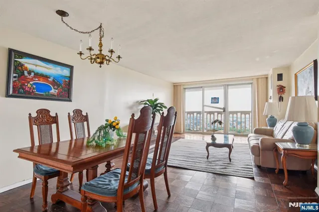 a view of a dining room with furniture wooden floor and a chandelier