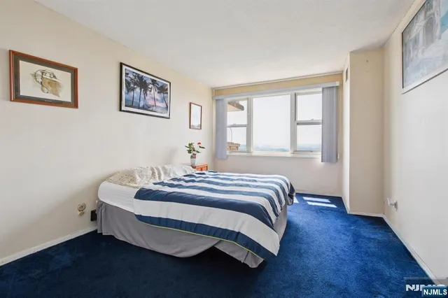 a bedroom with a bed and a potted plant