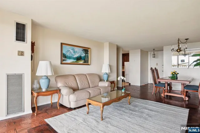 a living room with furniture a couch and wooden floor