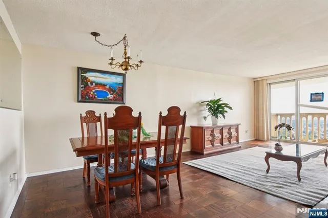 a view of a dining room with furniture and a potted plant