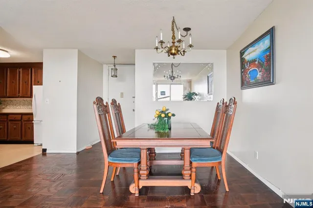 a view of a dining room with furniture wooden floor and a chandelier