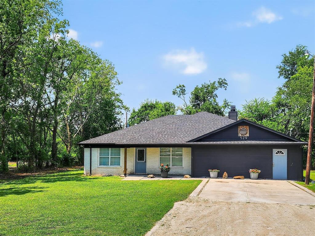 529 Celtic Road Howe, TX 75459 - Photo 1 of 16 a front view of a house with a garden