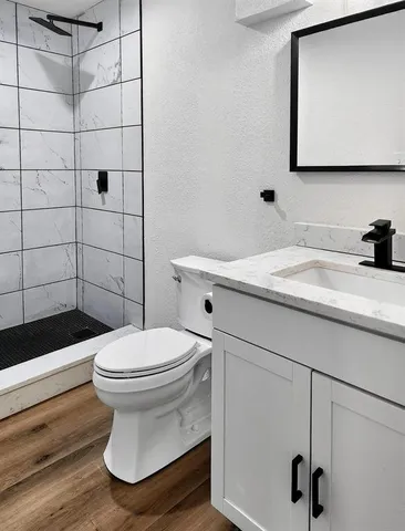 a bathroom with a sink toilet and shower