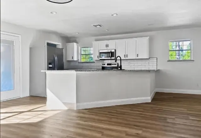 a kitchen with sink cabinets and window