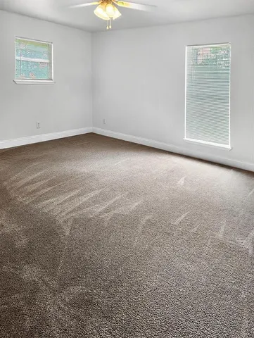 an empty room with a empty space and windows