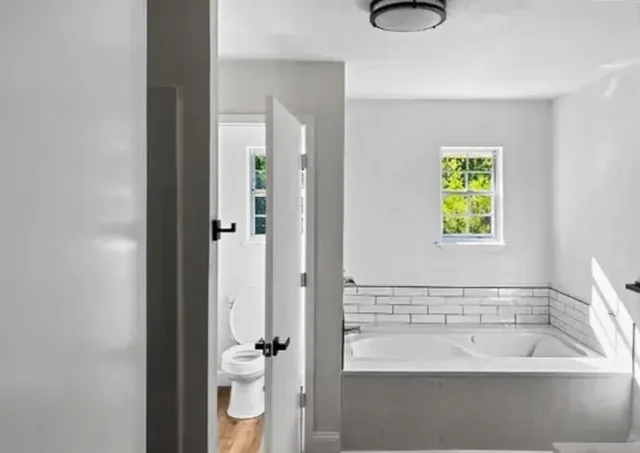 a bathroom with a bathtub and a shower