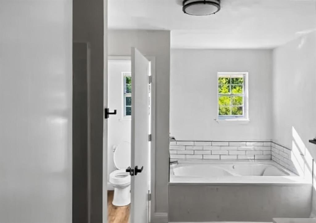 529 Celtic Road Howe, TX 75459 - Photo 8 of 16 a bathroom with a bathtub and a shower