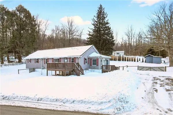 a view of a house with a yard covered in snow