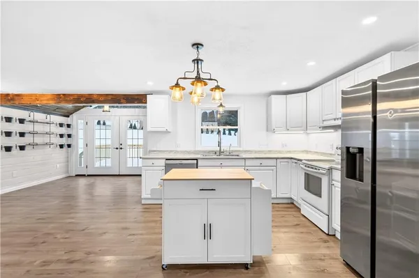 a kitchen with appliances cabinets and a sink