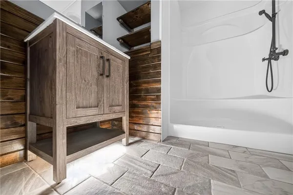 a view of a room that has a sink and dishwasher with wooden floor