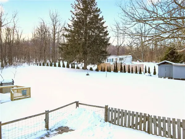 a wooden bench sitting in middle of a covered with snow