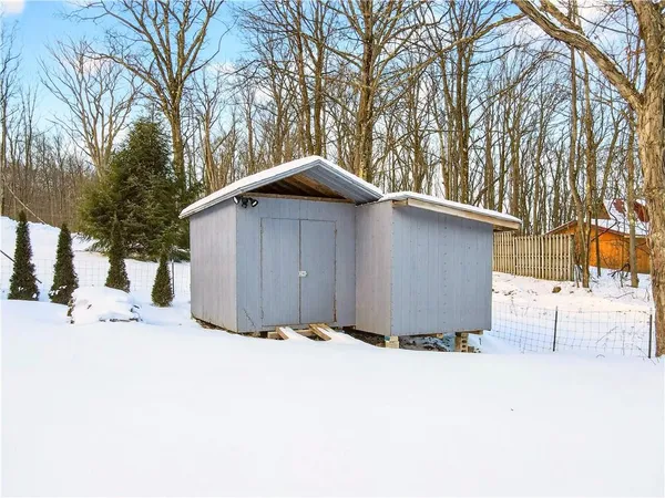 a view of residential houses with yard and covered with snow