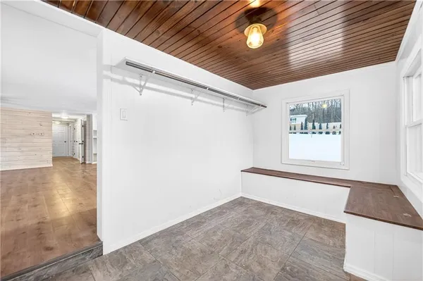 wooden floor in an empty room with a window