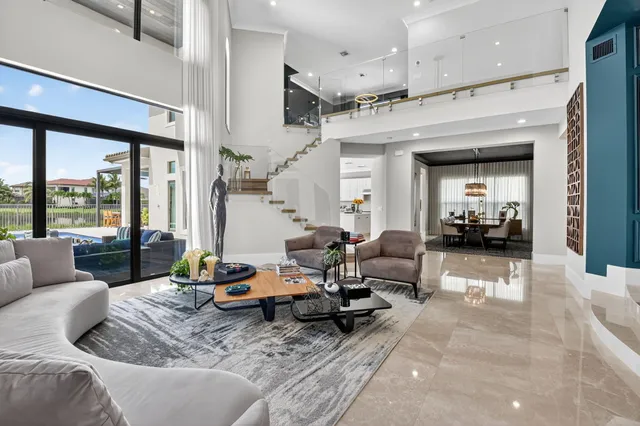 a kitchen with stainless steel appliances granite countertop a sink dishwasher stove and white cabinets