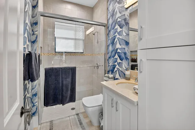 a view of swimming pool with a lounge chair and palm trees