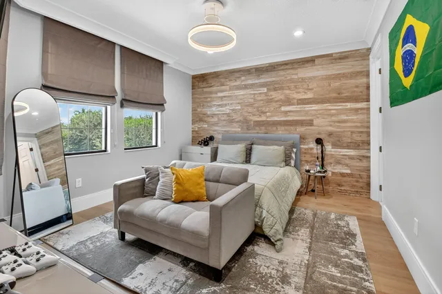 a front view of a house with a yard and palm trees