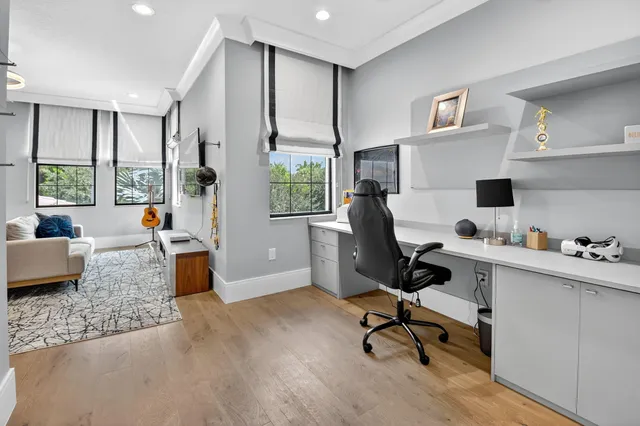 a very nice looking room with a large bed a chandelier and couches