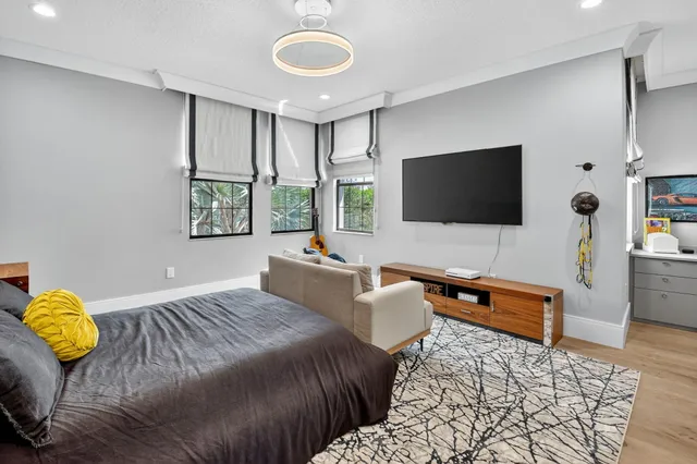 a view of swimming pool with outdoor seating and palm trees