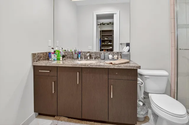 a view of a swimming pool with a lawn chairs under palm trees