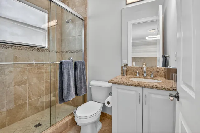 a view of a multi story building with yard and outdoor seating