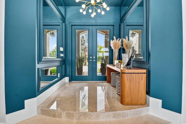 a living room with furniture flat screen tv and a large window