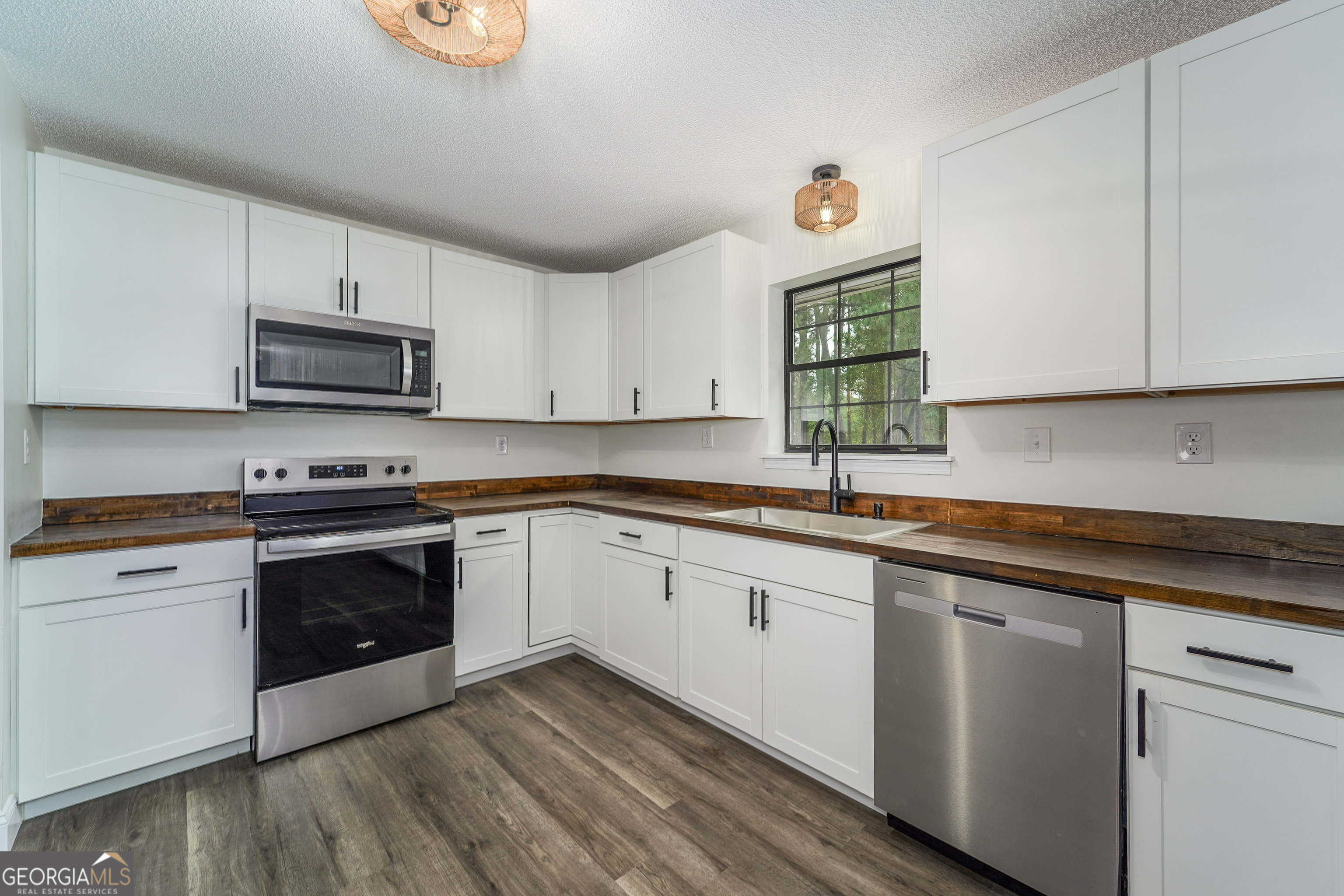 5406 Blue Spruce Road Blackshear, GA 31516 - Photo 12 of 28 a kitchen with cabinets appliances a sink and a window