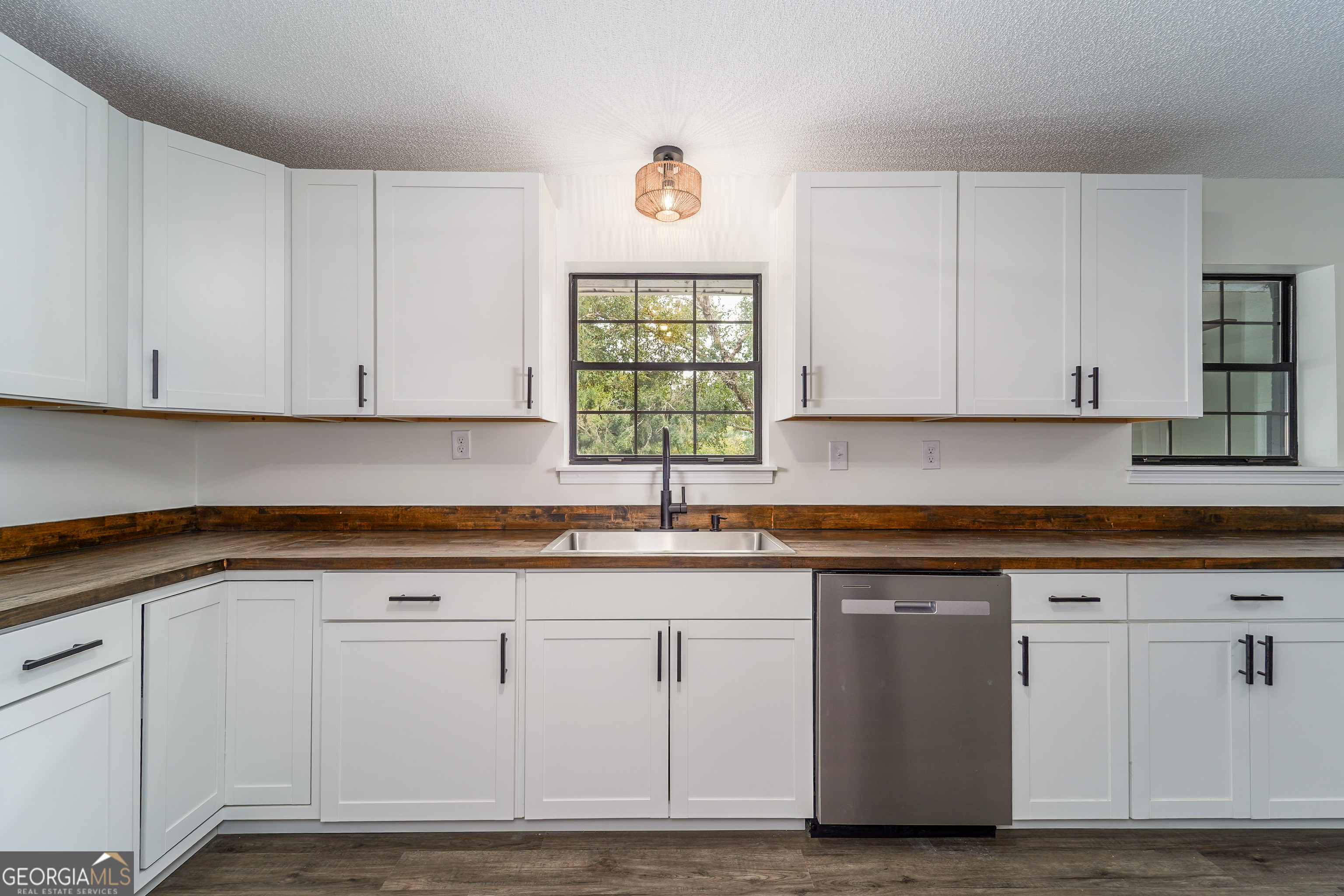 5406 Blue Spruce Road Blackshear, GA 31516 - Photo 13 of 28 a kitchen with granite countertop white cabinets and a window