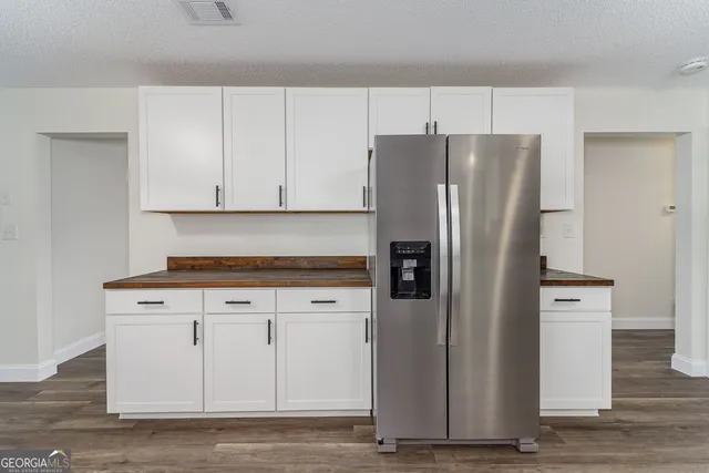 a kitchen with cabinets and stainless steel appliances