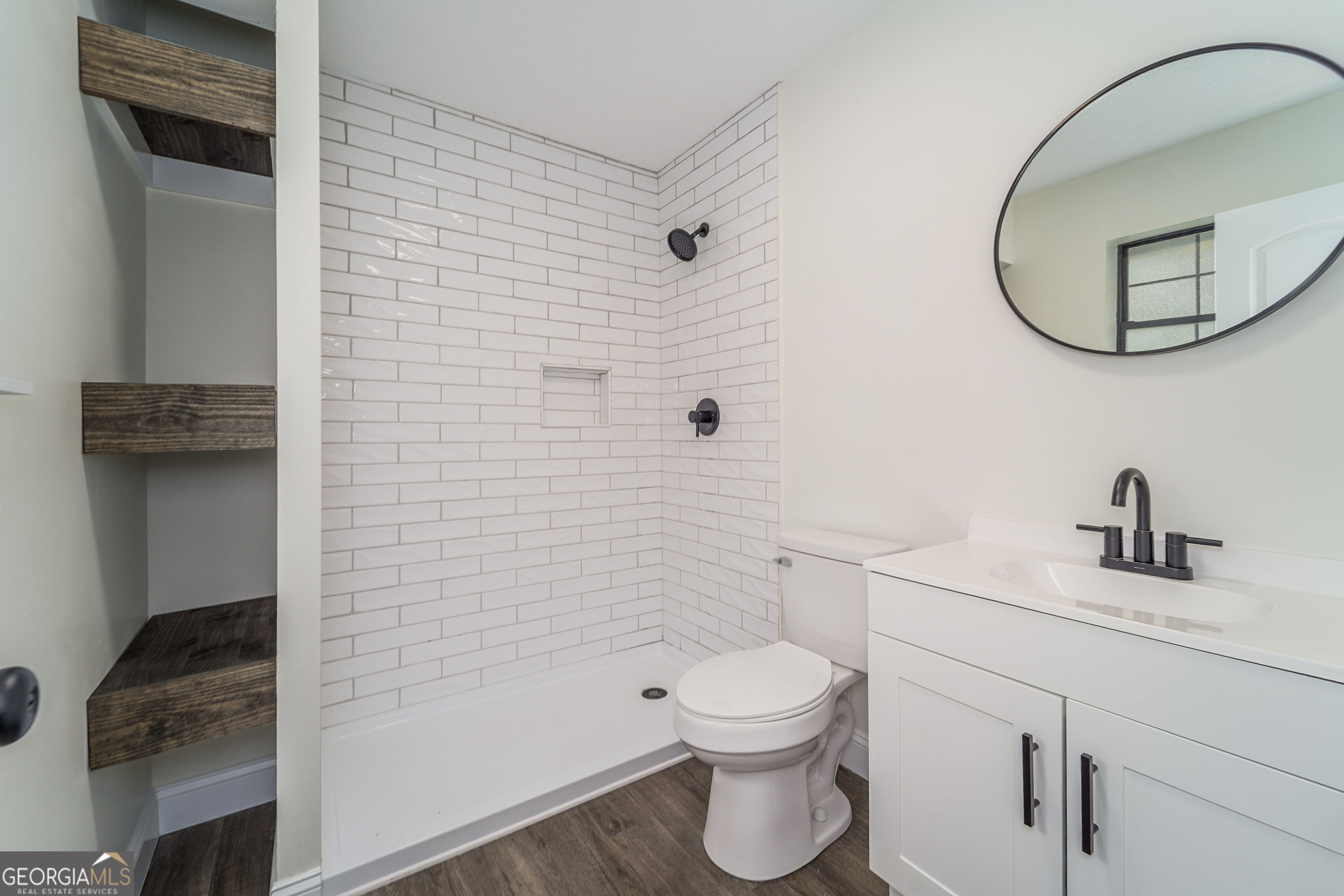 5406 Blue Spruce Road Blackshear, GA 31516 - Photo 20 of 28 a bathroom with a toilet a sink a shower and mirror