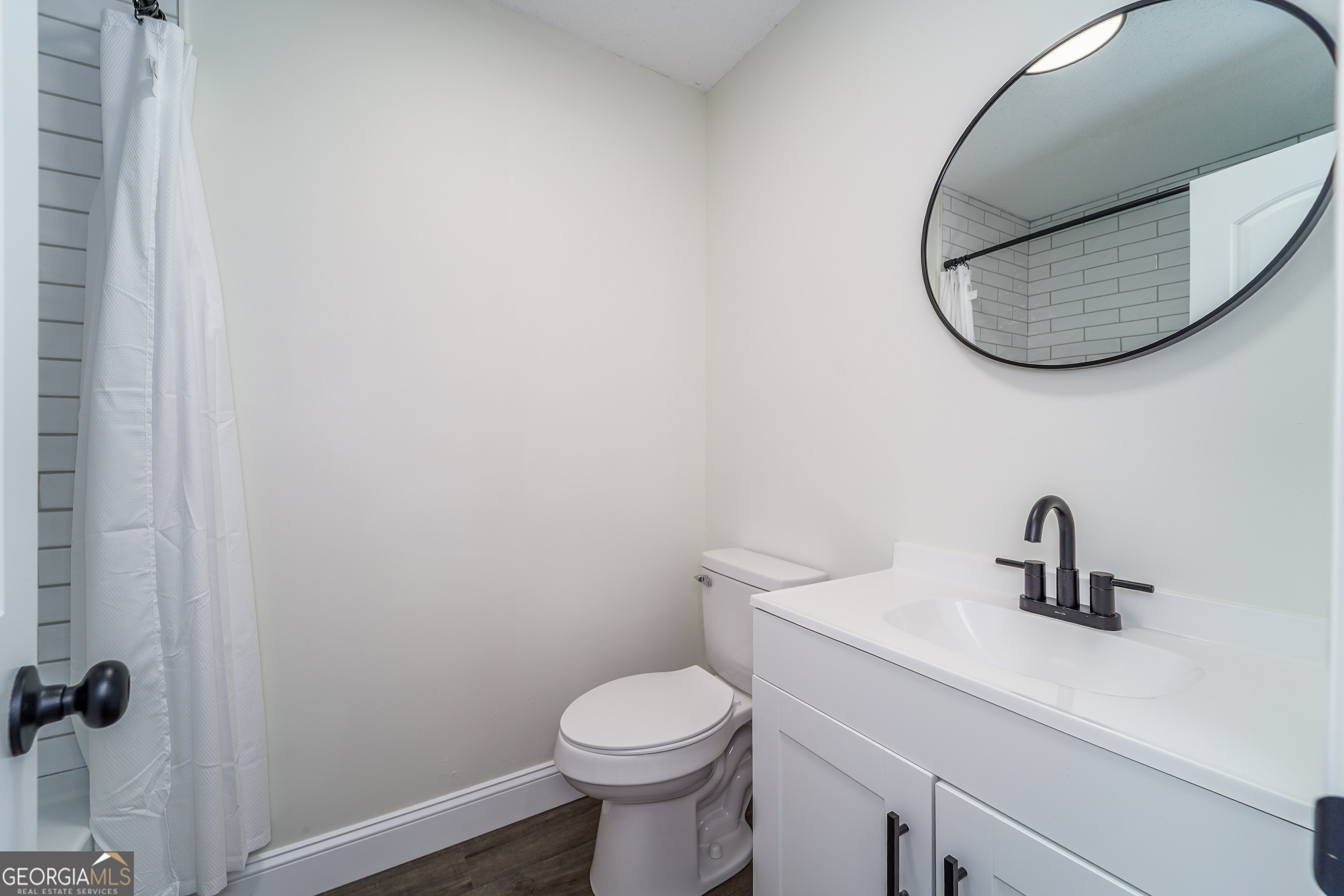 5406 Blue Spruce Road Blackshear, GA 31516 - Photo 23 of 28 a bathroom with a sink mirror and toilet