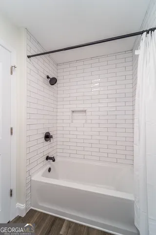 a bathroom with a bathtub and a shower