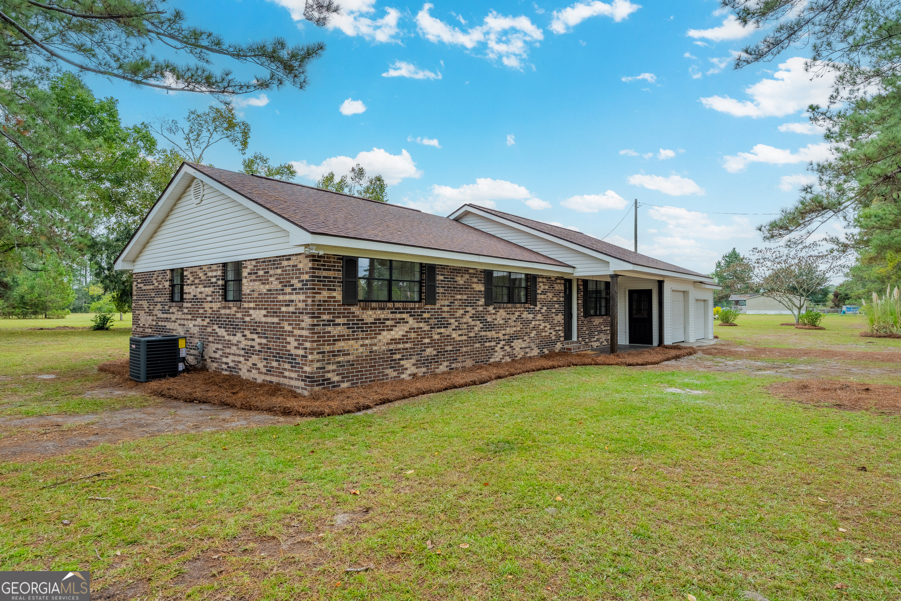 5406 Blue Spruce Road Blackshear, GA 31516 - Photo 4 of 28 a front view of a house with a garden and tree