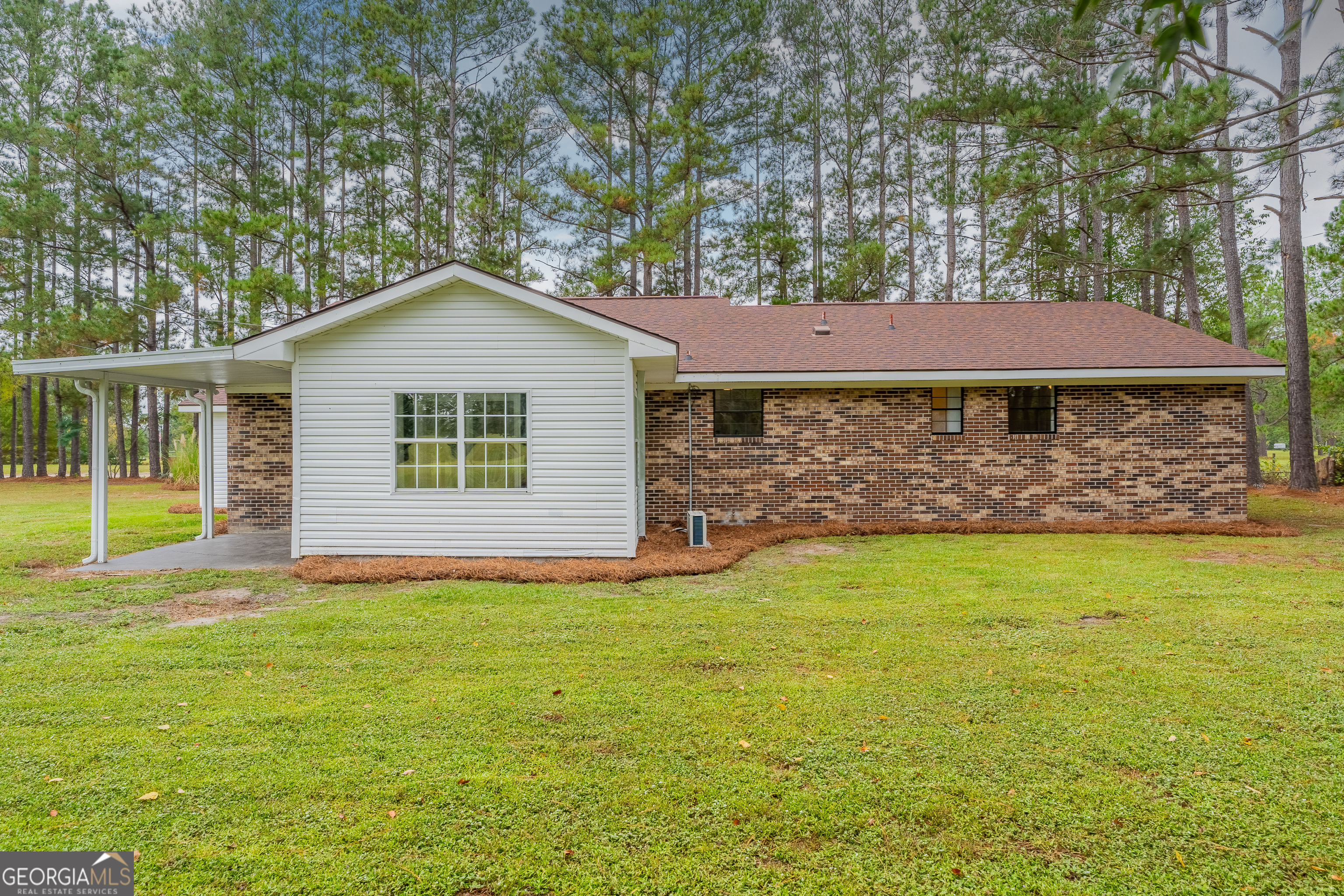 5406 Blue Spruce Road Blackshear, GA 31516 - Photo 6 of 28 a front view of a house with a garden