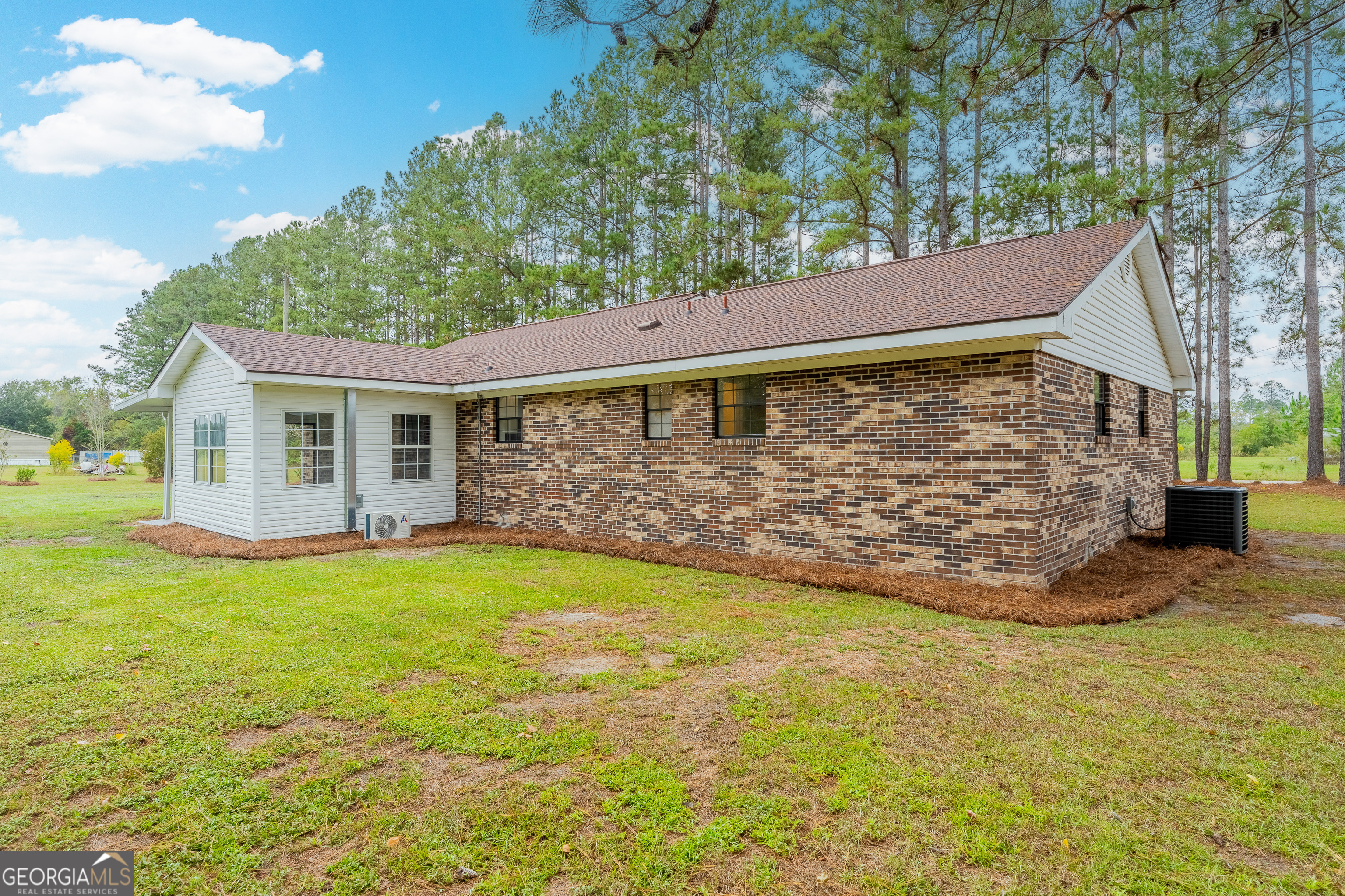5406 Blue Spruce Road Blackshear, GA 31516 - Photo 7 of 28 a view of a backyard with a garden and tree