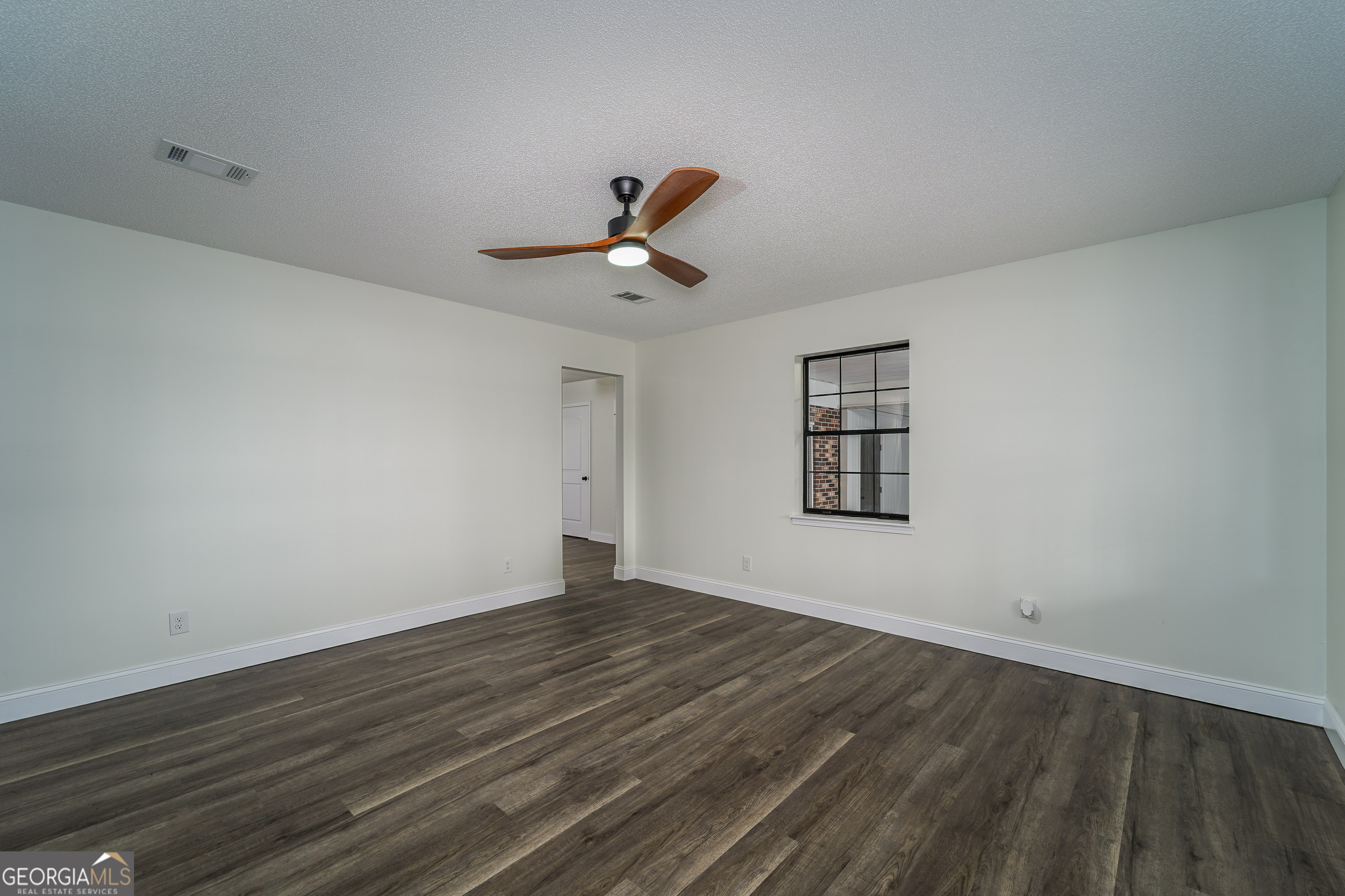 5406 Blue Spruce Road Blackshear, GA 31516 - Photo 8 of 28 a view of a room with wooden floor and ceiling fan