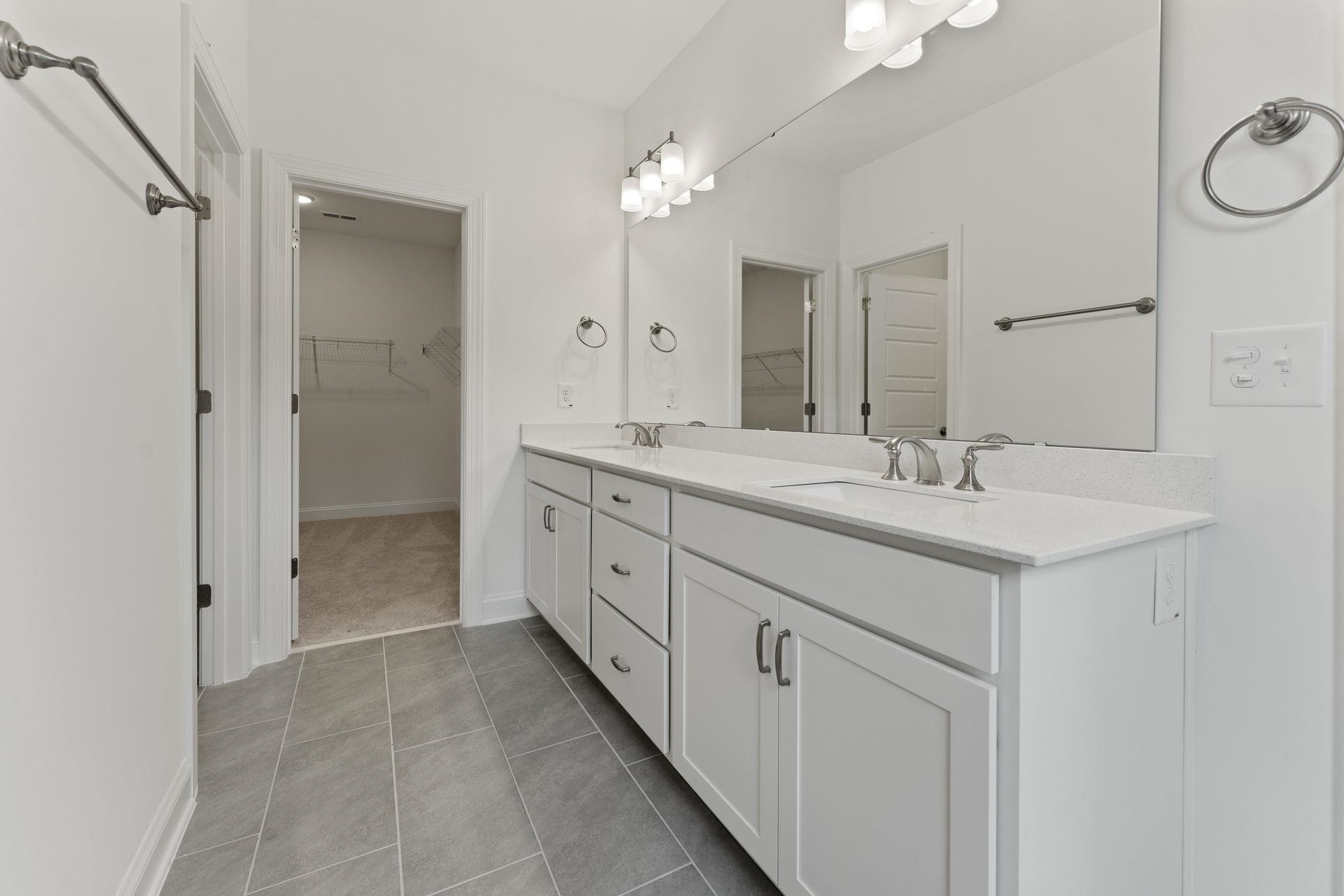 2128 Voekler Street Apex, NC 27502 - Photo 16 of 27 a spacious bathroom with a double vanity sink mirror and double