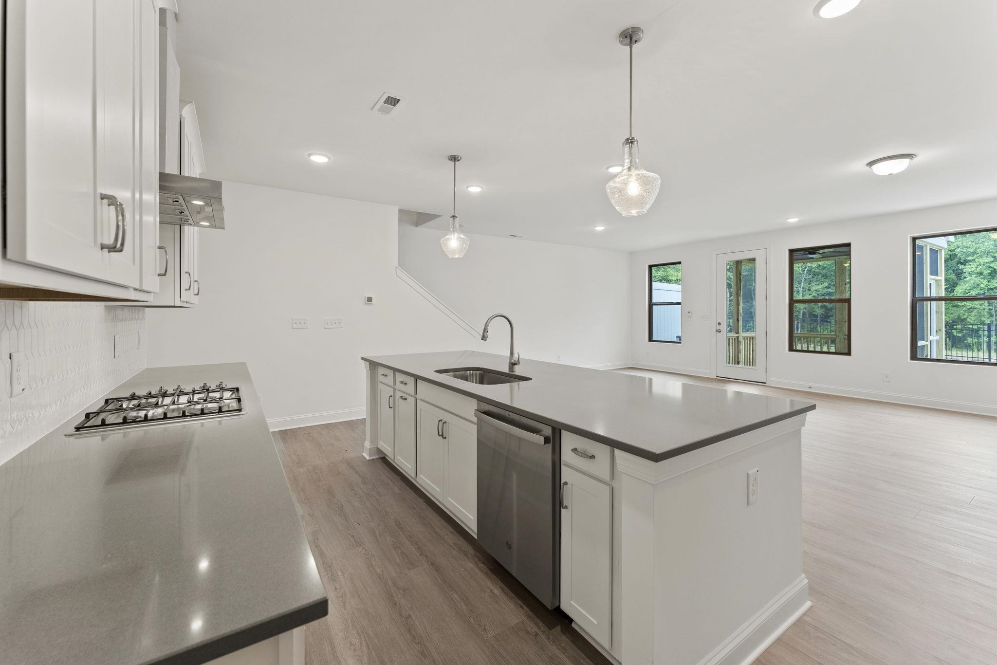 2128 Voekler Street Apex, NC 27502 - Photo 5 of 27 a kitchen with stainless steel appliances granite countertop a sink a stove and a wooden floors
