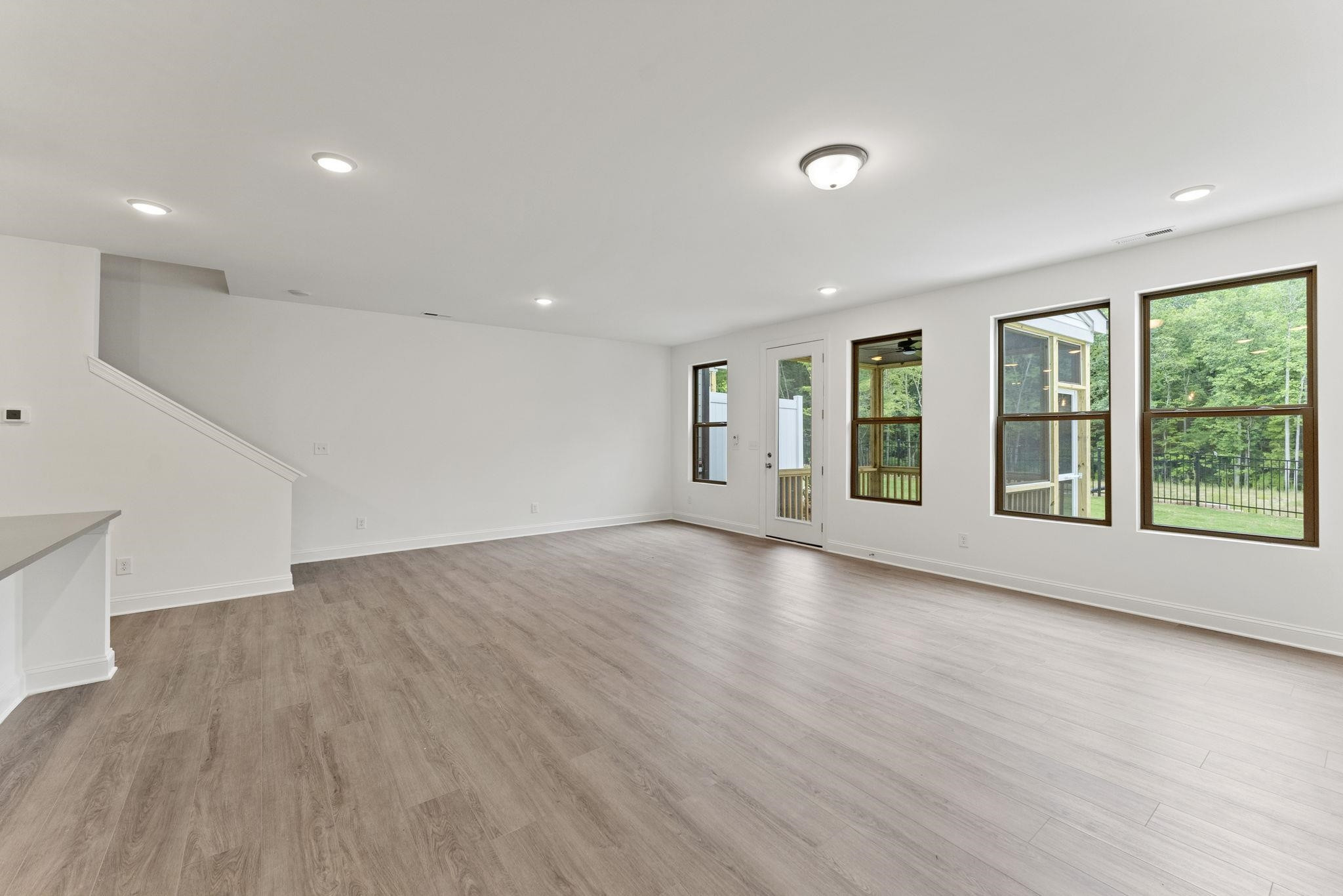 2128 Voekler Street Apex, NC 27502 - Photo 7 of 27 a view of an empty room with wooden floor and a window