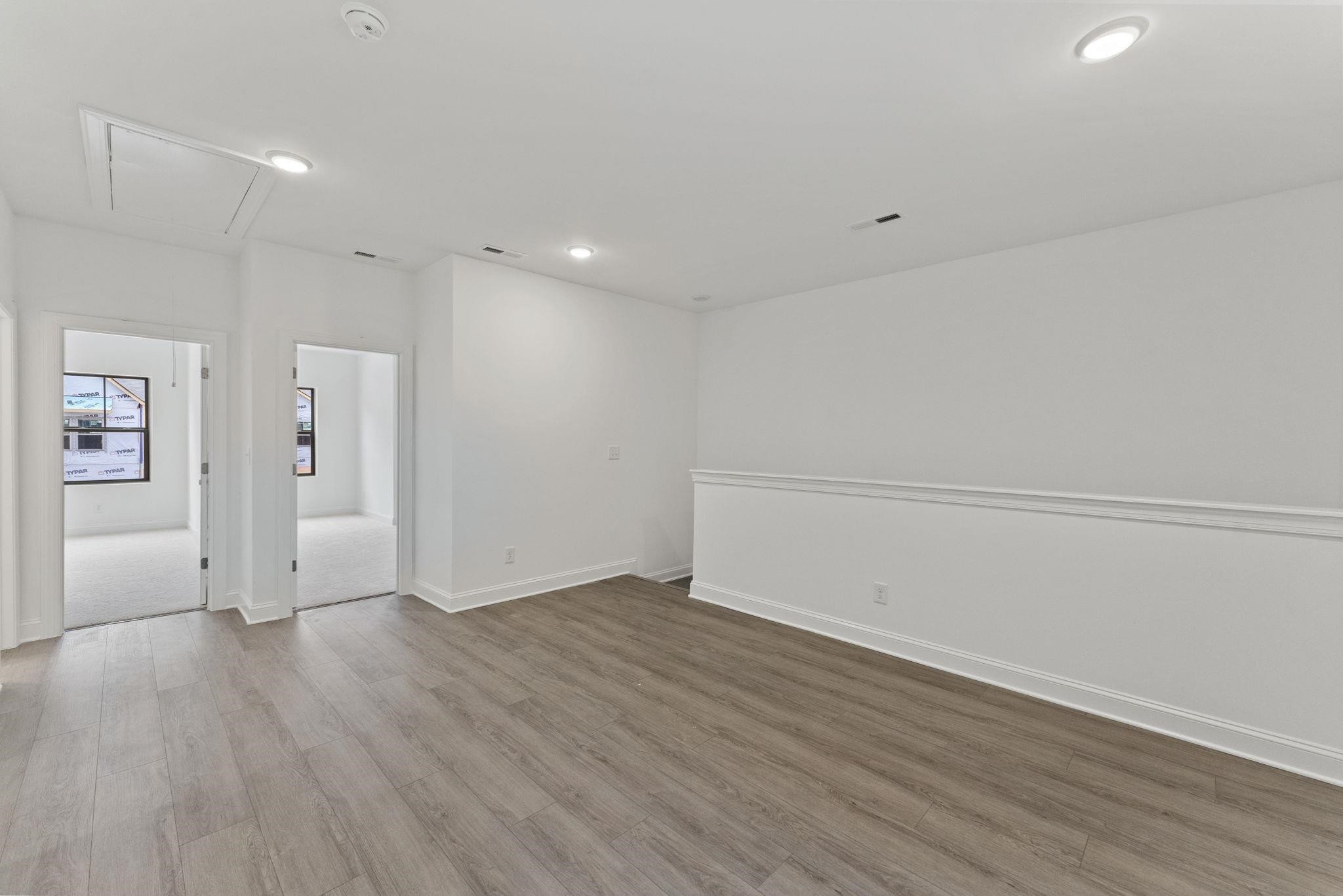 2128 Voekler Street Apex, NC 27502 - Photo 9 of 27 an empty room with wooden floor and windows
