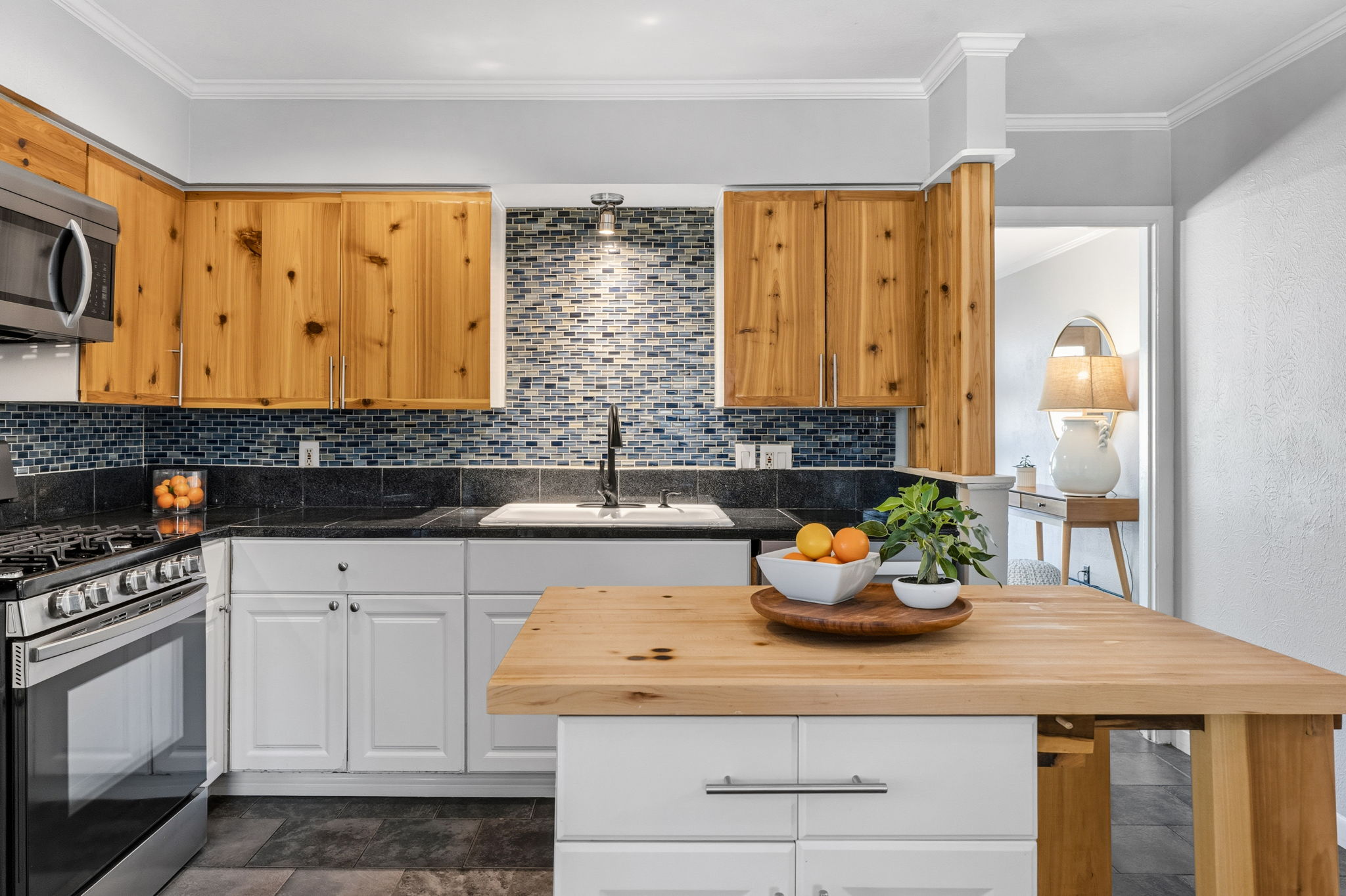 403 Gate Tree Lane Austin, TX 78745 - Photo 13 of 30 a kitchen with stainless steel appliances granite countertop a sink a stove and cabinets